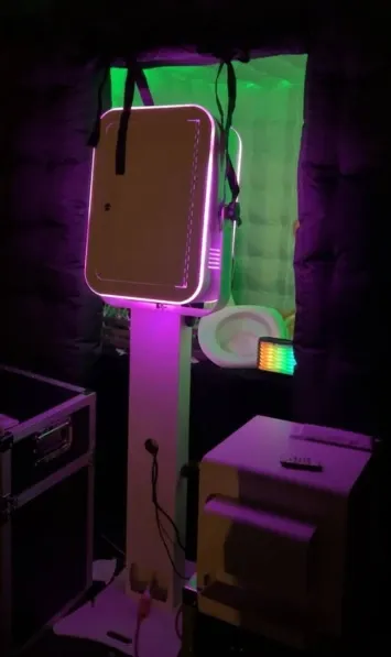 The photo booth lit up at night, with LED lighting inside the cabin